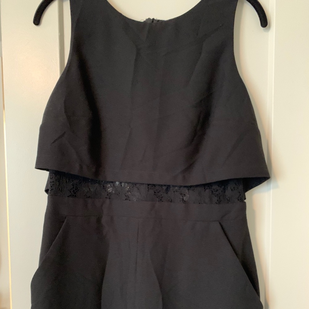 Black romper with lace detail and drape back